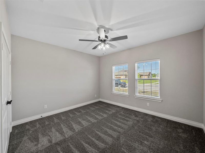 Unfurnished room with dark carpet and baseboards Unfurnished room with dark carpet and baseboards