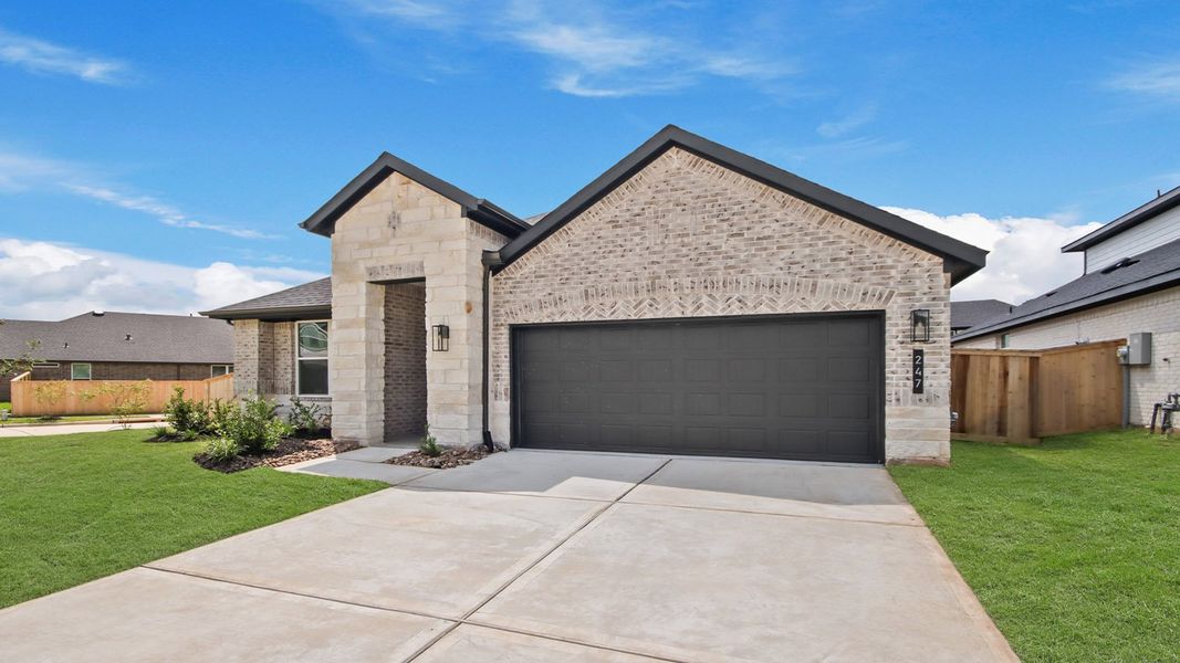 Front exterior of a new home in Hills of Westlake, Conroe, TX, highlighting curb appeal (Image 2). Front exterior of a new home in Hills of Westlake, Conroe, TX, highlighting curb appeal (Image 2).