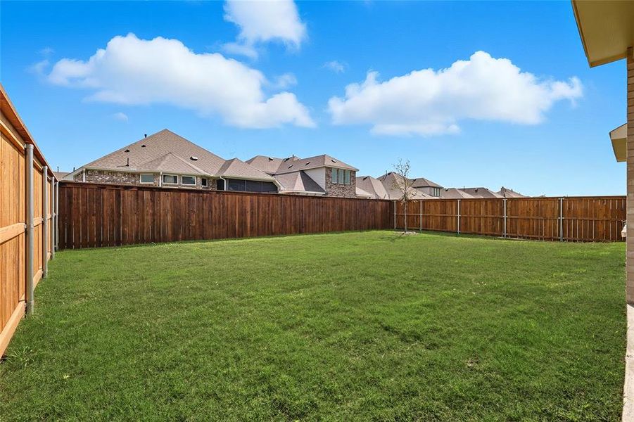 Fenced backyard featuring a residential view Fenced backyard featuring a residential view