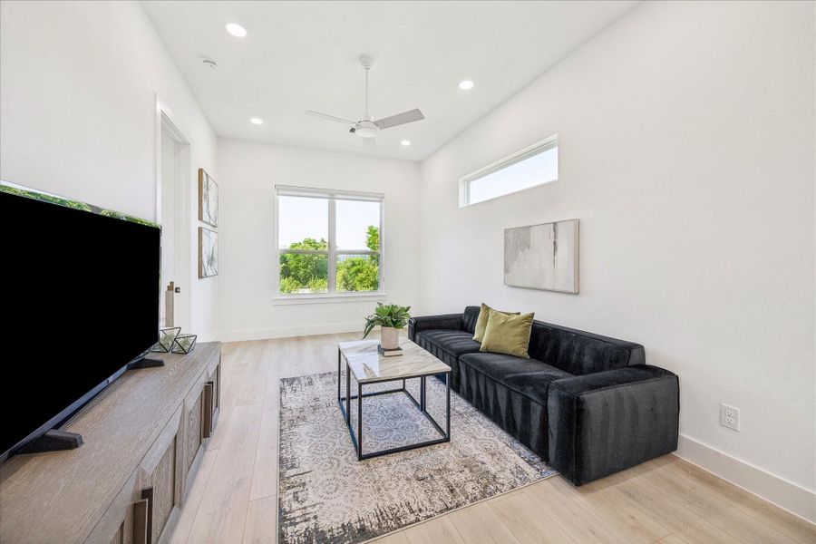 Ideal as a media room, playroom, home office, or secondary living area, this bright retreat features generous dimensions, recessed lighting, and warm wood look flooring.