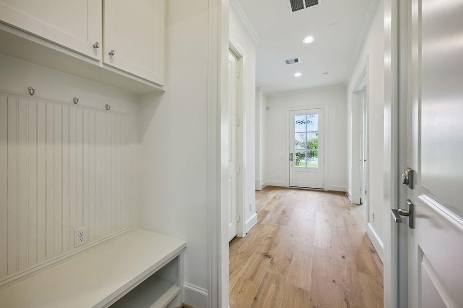 Functional mudroom/drop zone with built-in storage conveniently located near the garage.