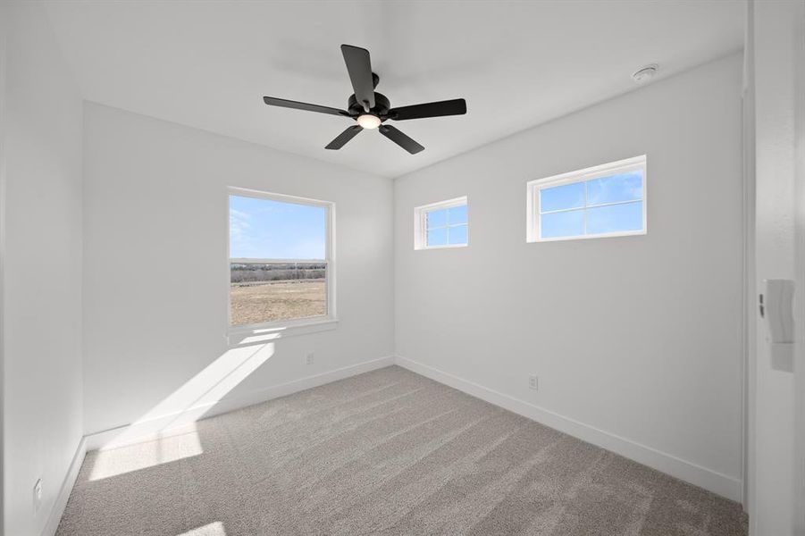 Unfurnished room with light carpet and a ceiling fan