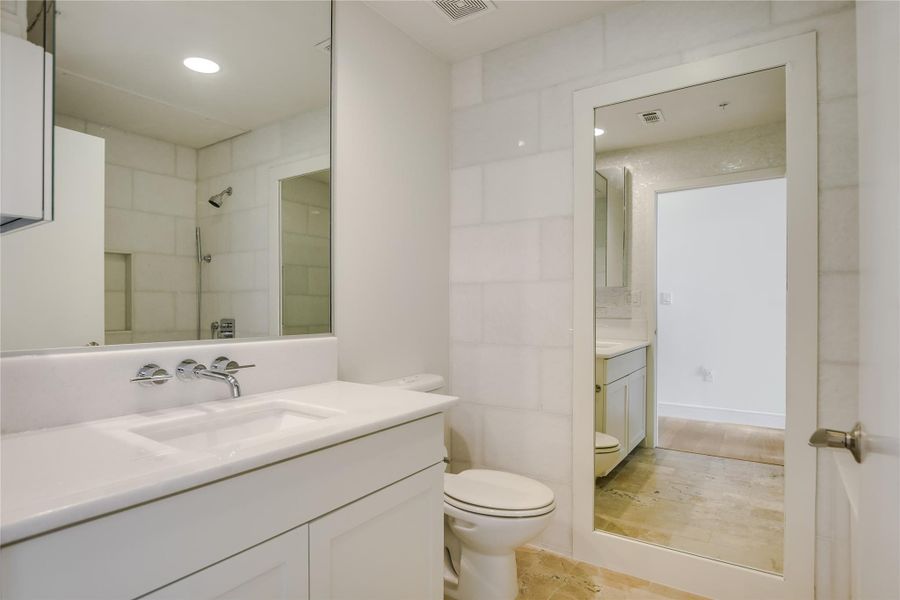 2nd Bath: Thassos marble waterfall surround, walls, and countertop. Limestone composite Victoria+Albert  soaking tub, Mother of Pearl accent wall (not pictured).