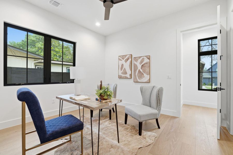 Home office featuring light wood-style floors, a ceiling fan, and recessed lighting