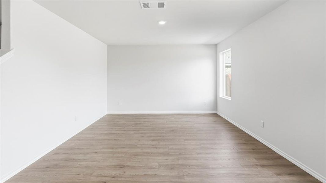Spare room with light wood-style floors and recessed lighting