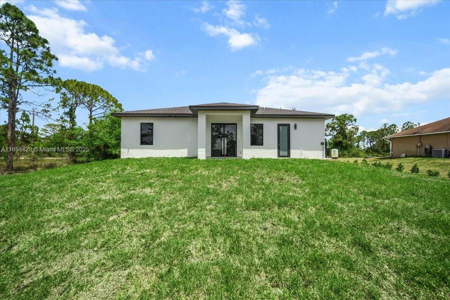 Front exterior of a new home in , Lehigh Acres, FL, highlighting curb appeal (Image 19). Front exterior of a new home in , Lehigh Acres, FL, highlighting curb appeal (Image 19).