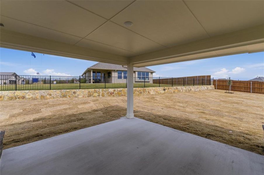 Fenced backyard with a patio
