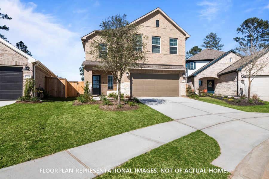 Front exterior of a new home in Marvida, Cypress, TX, highlighting curb appeal (Image 16). Front exterior of a new home in Marvida, Cypress, TX, highlighting curb appeal (Image 16).