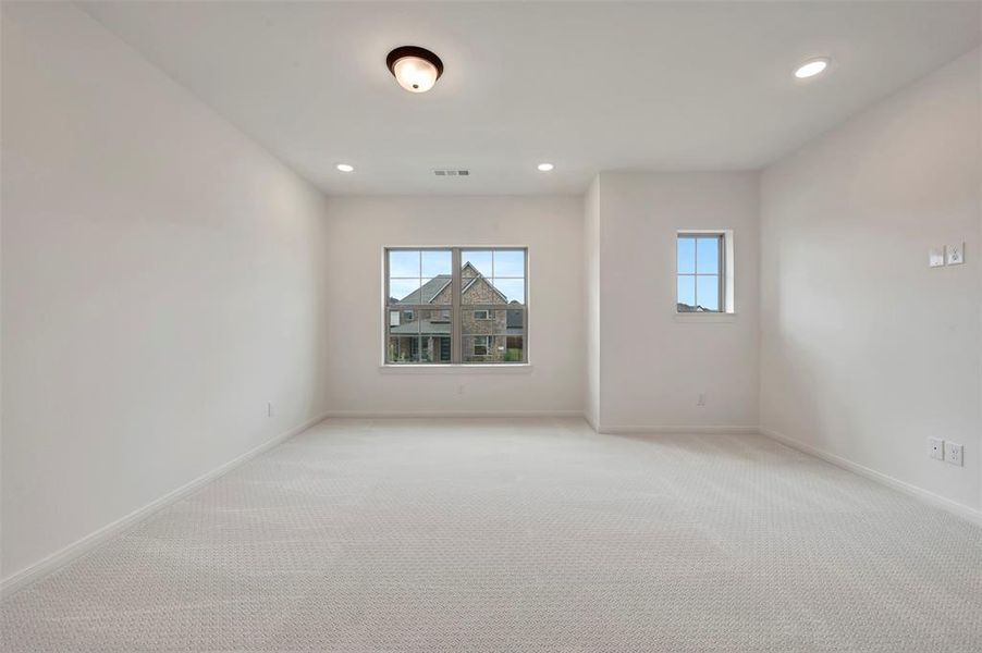 Unfurnished room with recessed lighting and light carpet