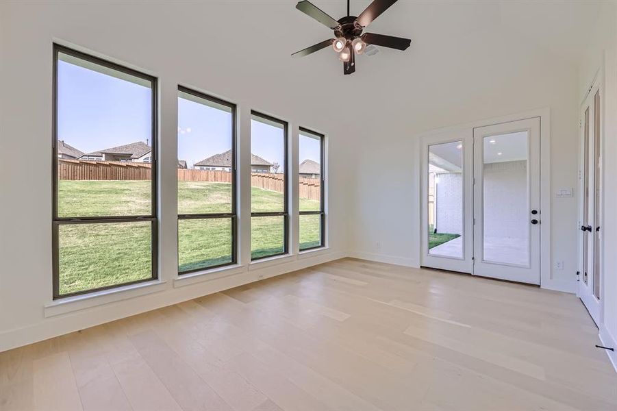 Spare room with ceiling fan and light wood-type flooring