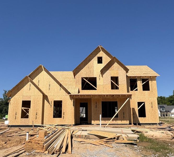 Newly constructed frame home featuring multiple gables and varied rooflines