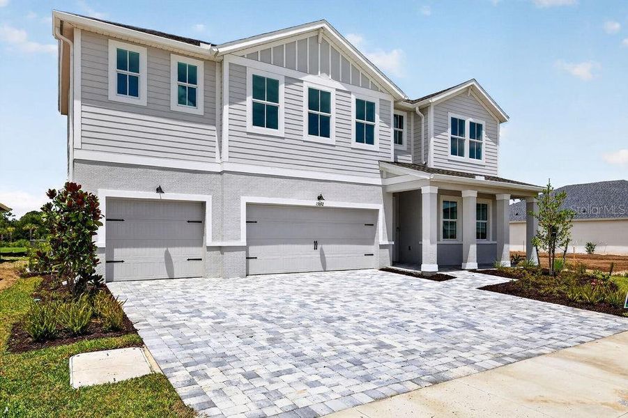 Front exterior of a new home in The Sanctuary – Royal Collection, Punta Gorda, FL, highlighting curb appeal (Image 2). Front exterior of a new home in The Sanctuary – Royal Collection, Punta Gorda, FL, highlighting curb appeal (Image 2).