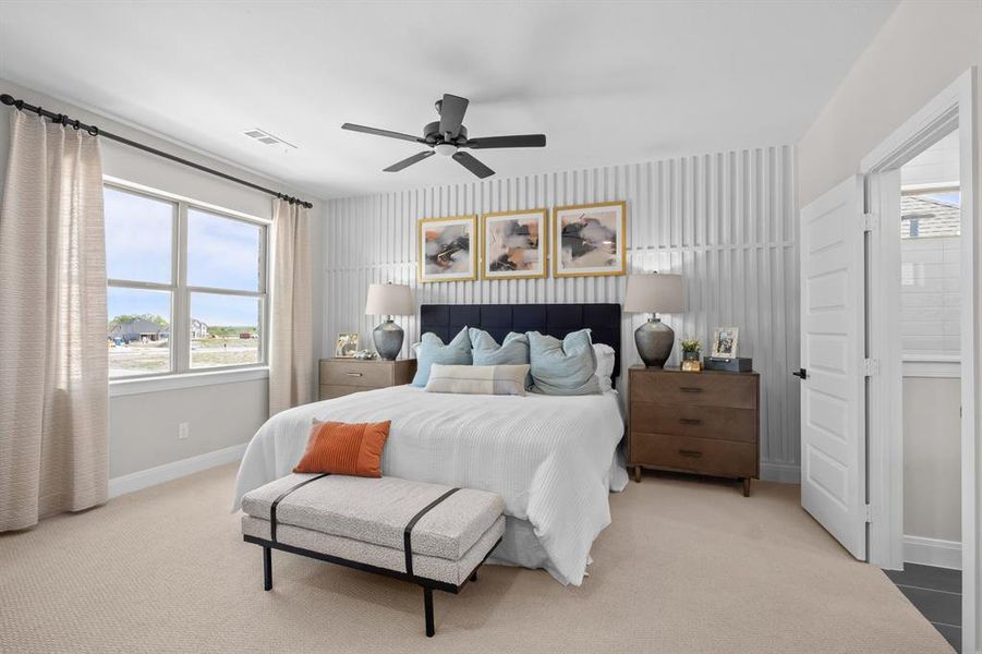 Bedroom with light carpet and a ceiling fan