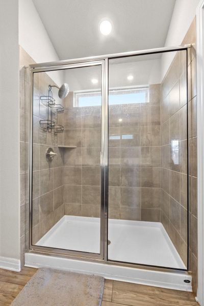 Full bathroom featuring light wood-type flooring and a stall shower Full bathroom featuring light wood-type flooring and a stall shower