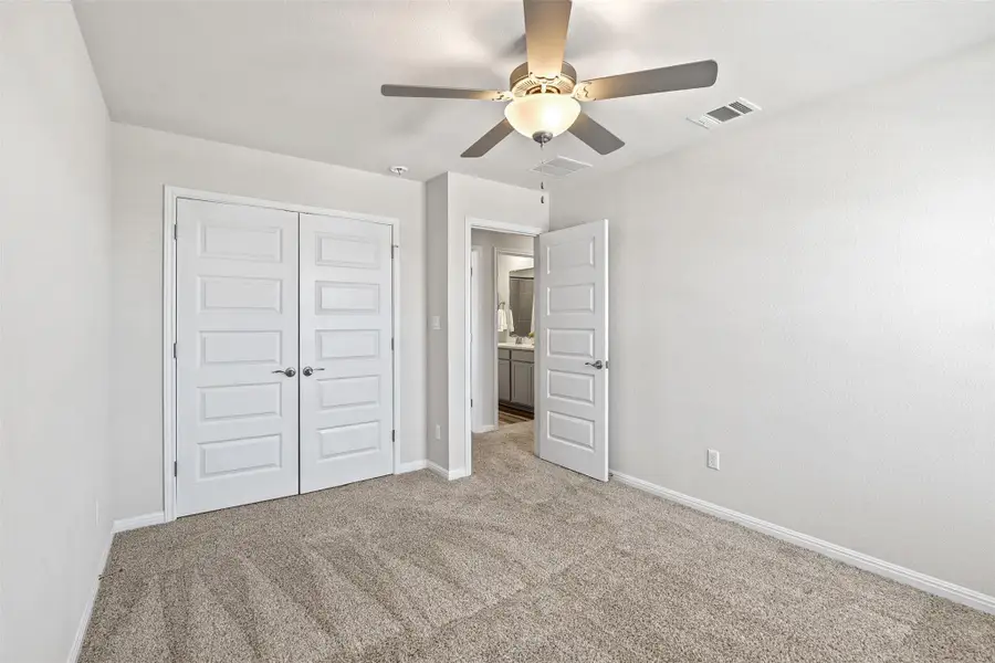 Unfurnished bedroom featuring carpet floors, a closet, and ceiling fan Unfurnished bedroom featuring carpet floors, a closet, and ceiling fan
