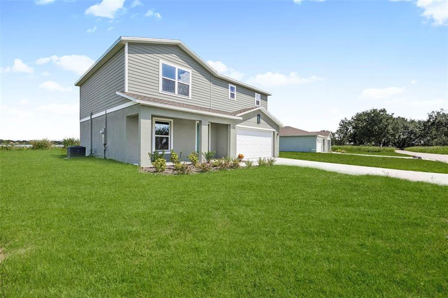 Front exterior of a new home in Scenic Terrace, Haines City, FL, highlighting curb appeal (Image 7).