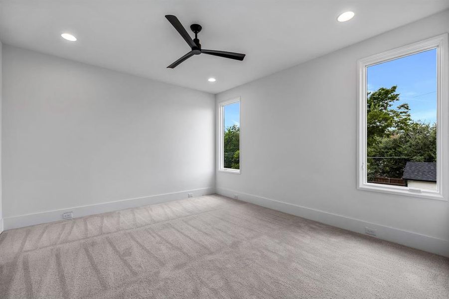 Unfurnished room with light carpet and ceiling fan