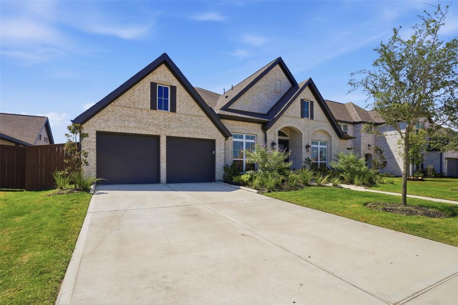 Expansive double-wide driveway leads to a 3-car tandem garage with additional space forstorage or hobbies. Expansive double-wide driveway leads to a 3-car tandem garage with additional space forstorage or hobbies.