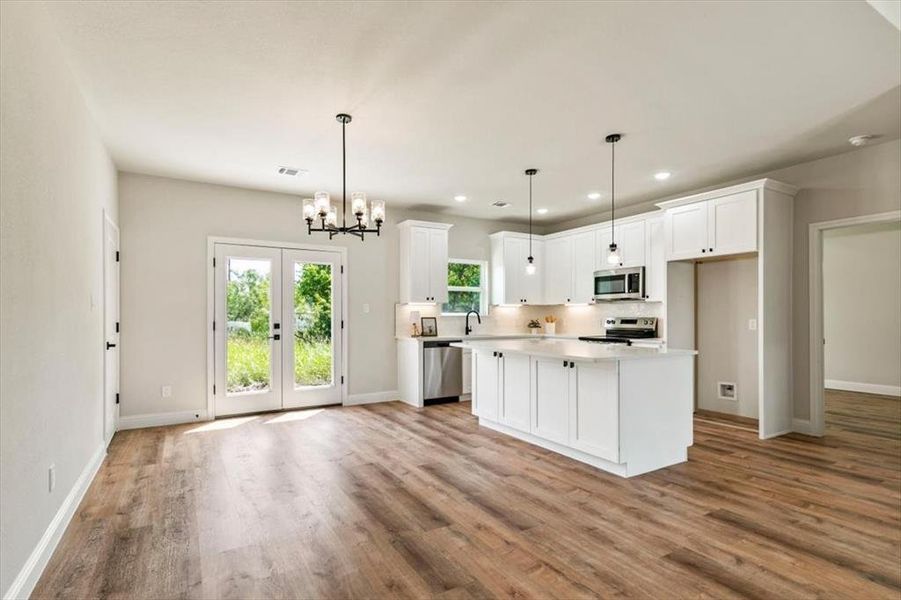 Open-concept living space with wood-finish flooring