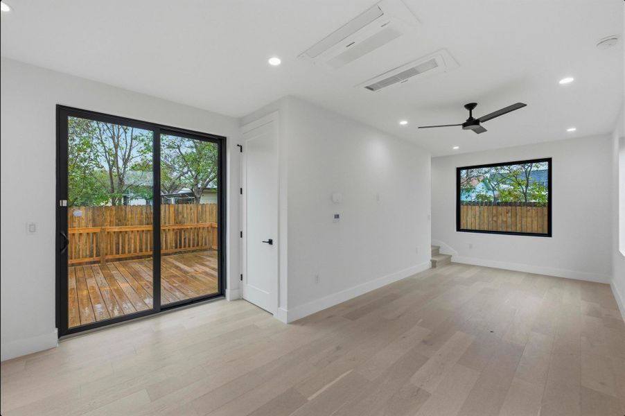 Unfurnished room with light wood-type flooring, a ceiling fan, cooling unit, and recessed lighting Unfurnished room with light wood-type flooring, a ceiling fan, cooling unit, and recessed lighting