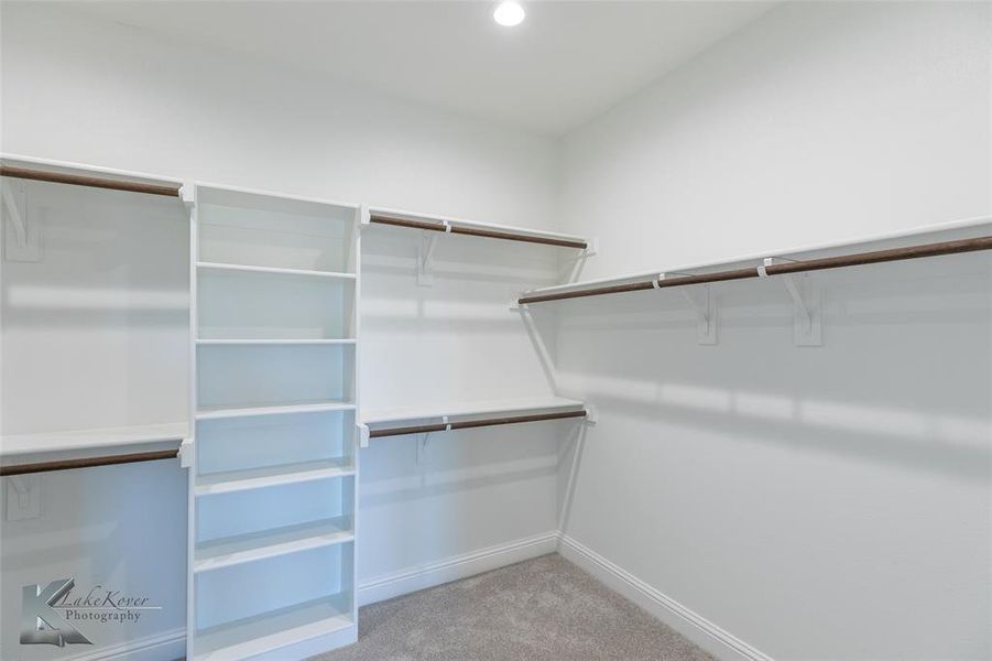 Walk in closet featuring light carpet