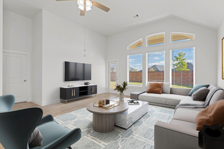 Bright and spacious family room featuring soaring ceilings and a stunning wall of windows that bring in beautiful natural light. The open layout offers plenty of room for comfortable seating and easy entertaining. Virtual staging highlights how perfectly this space fits your everyday living and relaxing needs! *Virtually Staged*