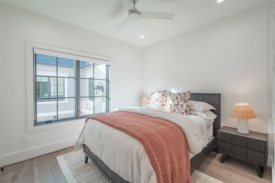 Bedroom with ceiling fan and light hardwood / wood-style floors