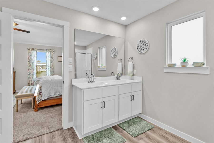 Primary Bath, offers duel sinks, and a window for added natural lighting.