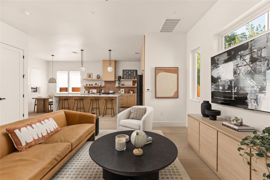 Living room featuring light wood-style flooring and baseboards