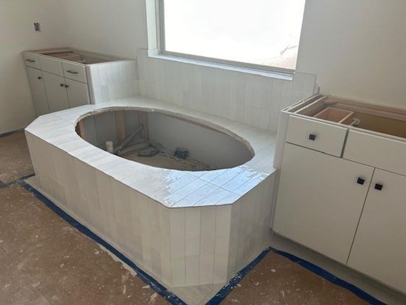 Vanity area in primary bathroom.  Stunning tile included around tub and in shower area.