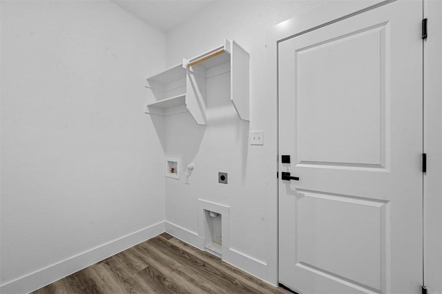 Laundry room with hookup for an electric dryer, hookup for a gas dryer, hardwood / wood-style floors, and hookup for a washing machine