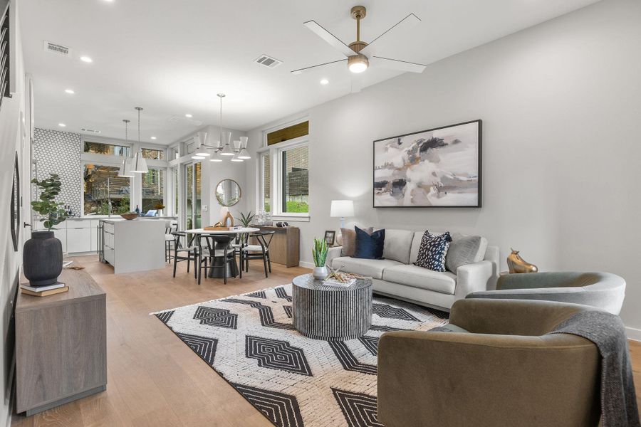 Living room with recessed lighting, visible vents, and light wood-style flooring