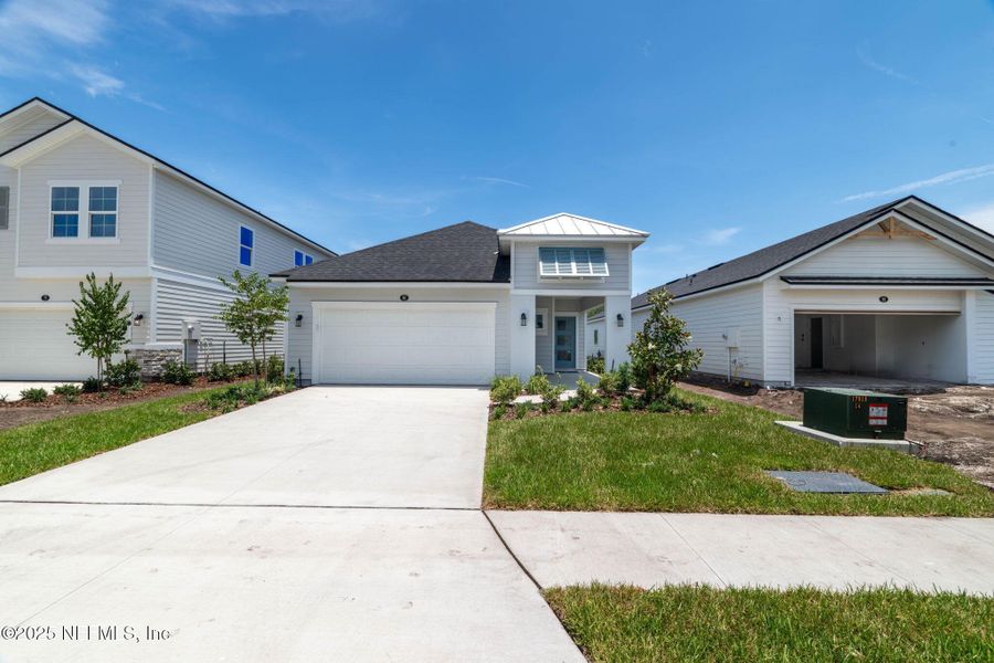 Front exterior of a new home in Beacon Lake, St. Augustine, FL, highlighting curb appeal (Image 22).