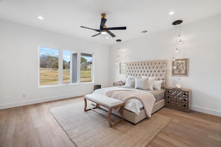 Bedroom featuring baseboards, recessed lighting, visible vents, and light wood-style floors