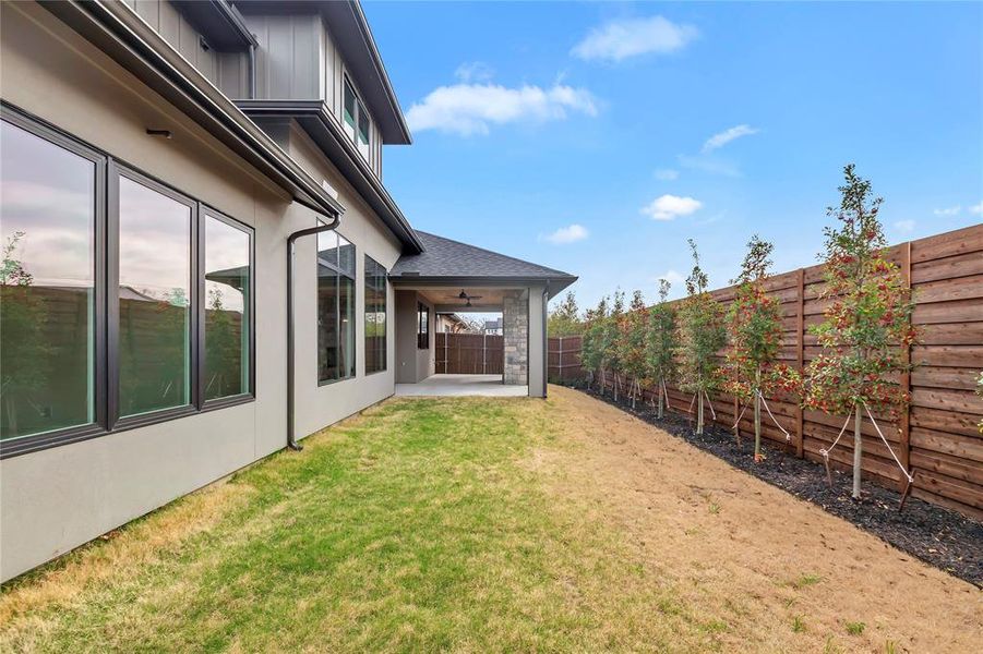 Fenced backyard featuring a patio and ceiling fan Fenced backyard featuring a patio and ceiling fan