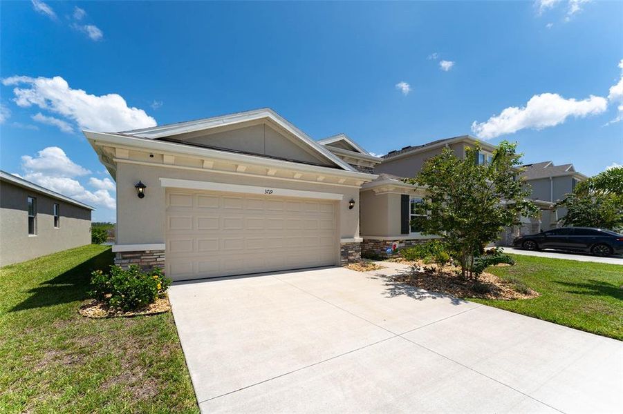 Front exterior of a new home in Evergreen, Bradenton, FL, highlighting curb appeal (Image 2). Front exterior of a new home in Evergreen, Bradenton, FL, highlighting curb appeal (Image 2).