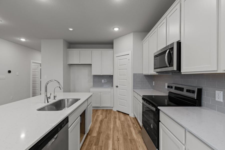 A kitchen with white cabinets. A kitchen with white cabinets.