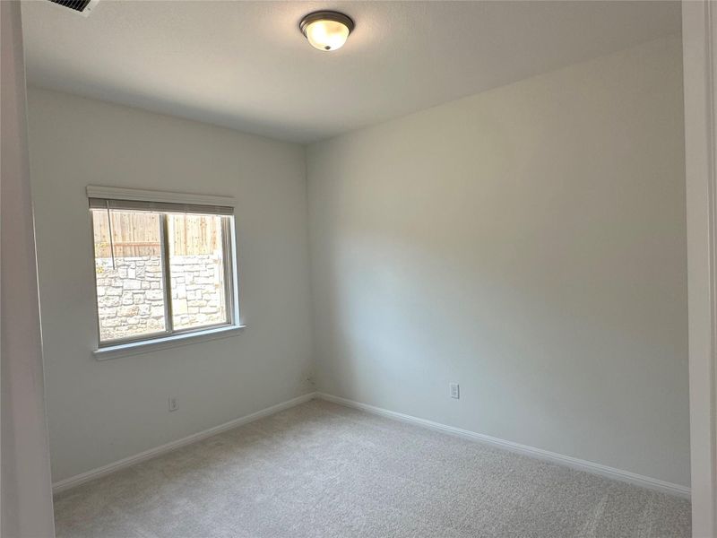 Spare room with light carpet and baseboards