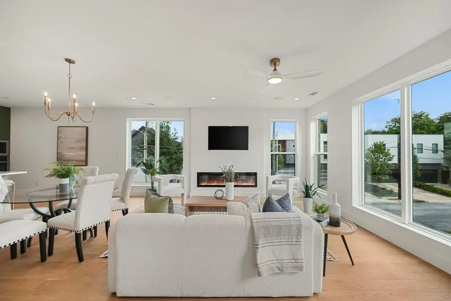 Open-concept living area with light wood-finish flooring Open-concept living area with light wood-finish flooring