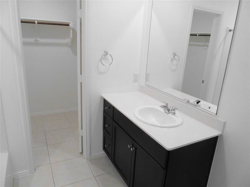 Bathroom with vanity and tile patterned flooring