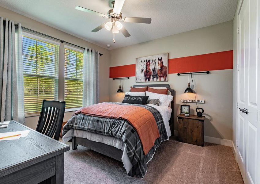 Boys room with bed, desk and horse artwork.