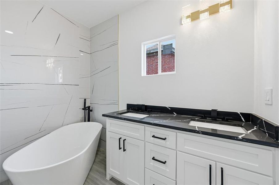 Full bath featuring a freestanding bath and double vanity Full bath featuring a freestanding bath and double vanity
