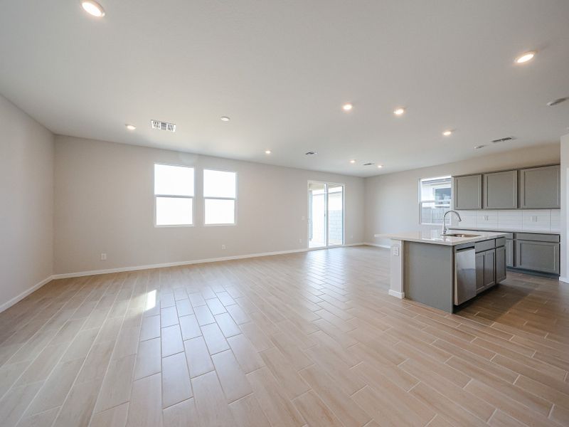 A large kitchen with a wood floor. A large kitchen with a wood floor.