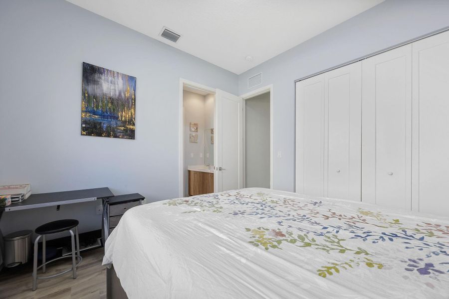 Bedroom featuring wood finished floors and a closet