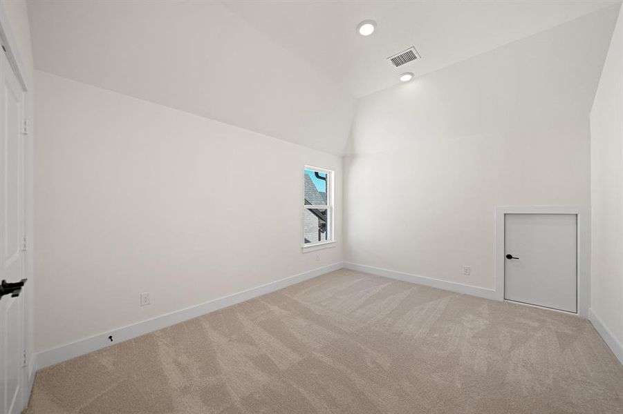 Spare room with light colored carpet, high vaulted ceiling, and recessed lighting Spare room with light colored carpet, high vaulted ceiling, and recessed lighting