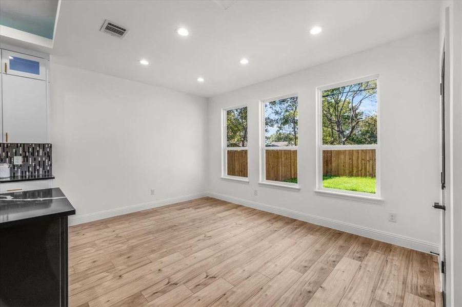 Unfurnished dining area featuring recessed lighting, light wood-style floors, and healthy amount of natural light
