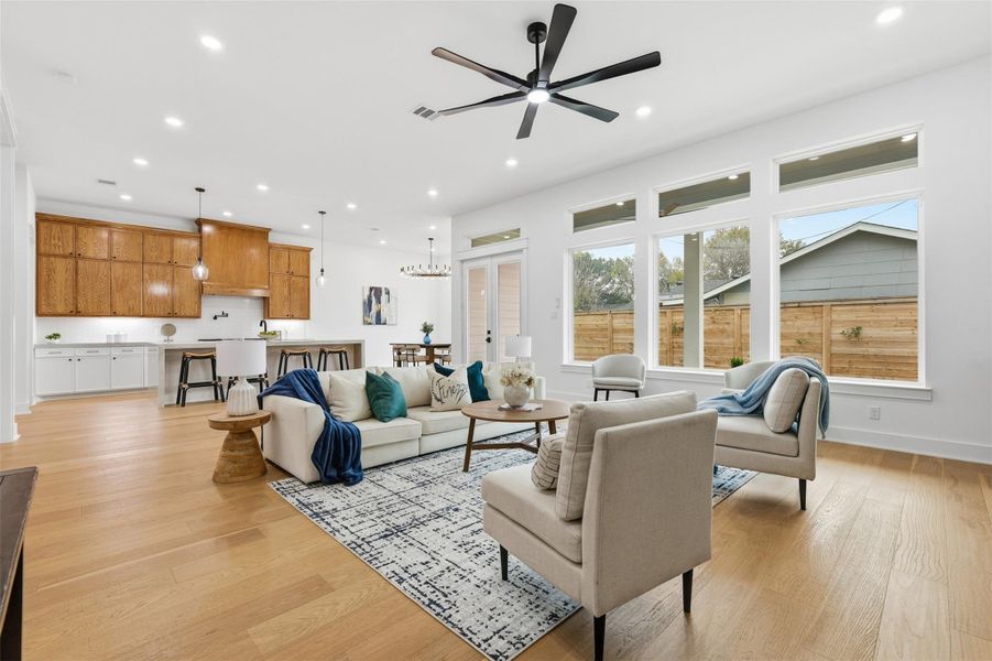 Glass double doors open to the outdoor living area, creating a seamless indoor–outdoor connection.