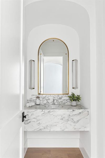 Half bathroom with vanity and wood finished floors Half bathroom with vanity and wood finished floors