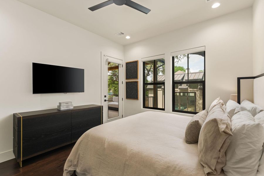 The primary bedroom has access to the backyard, covered patio, and pool.