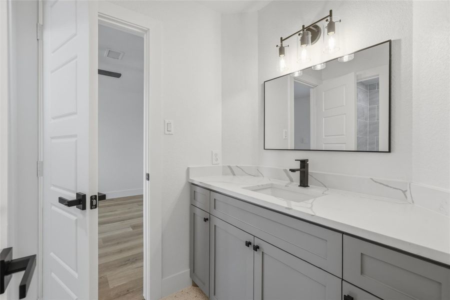 Beautiful modern upstairs bathroom with quartz counters, modern lighting, gray cabinetry, black hardware. Beautiful modern upstairs bathroom with quartz counters, modern lighting, gray cabinetry, black hardware.